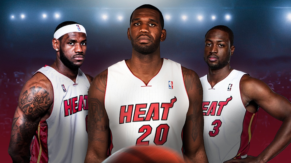 Greg Oden wearing Heat uniform looking at LeBron James and Dwyane Wade looking serious also wearing Heat uniform