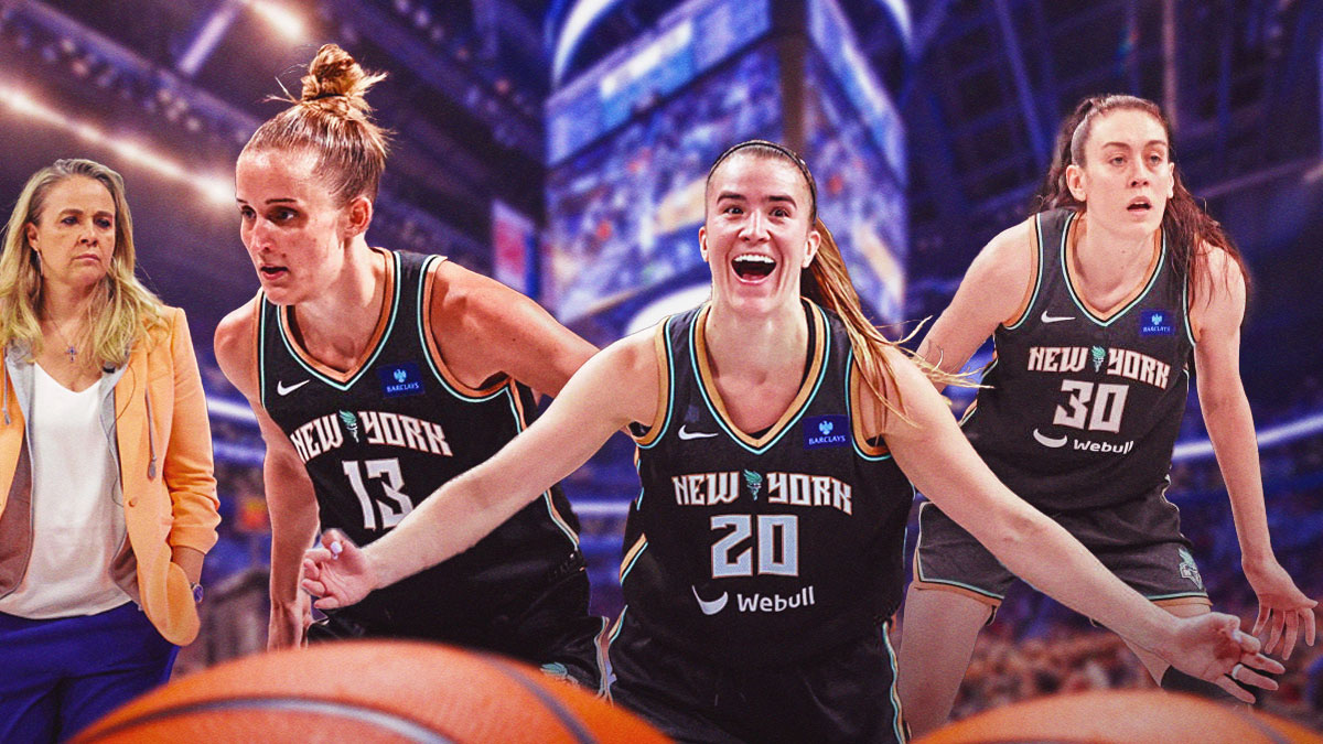 Breanna Stewart, Sabrina Ionescu, Leonie Fiebich (Liberty) all playing defense. Concerned Becky Hammon (Aces coach) in background. Barclays Center interior.
