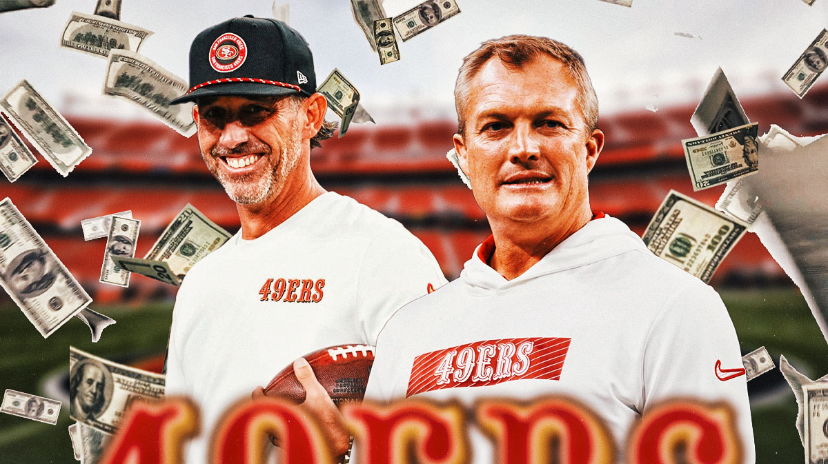 49ers coach Kyle Shanahan and GM John Lynch smiling with money falling all around them, 49ers background.