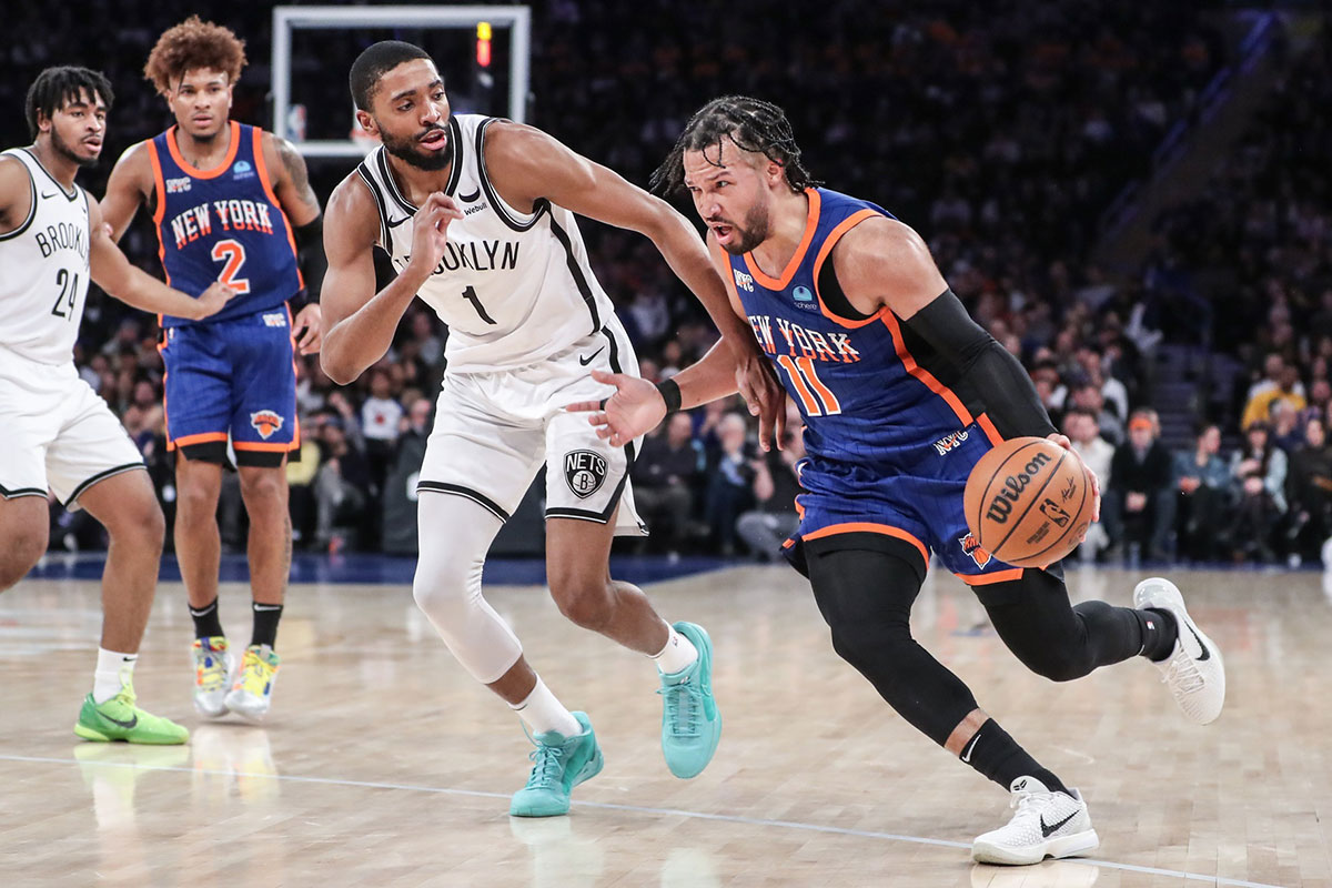 New York Knicks guard Jalen Brunson (11) drives past Brooklyn Nets forward Mikal Bridges (1) in the third quarter at Madison Square Garden.