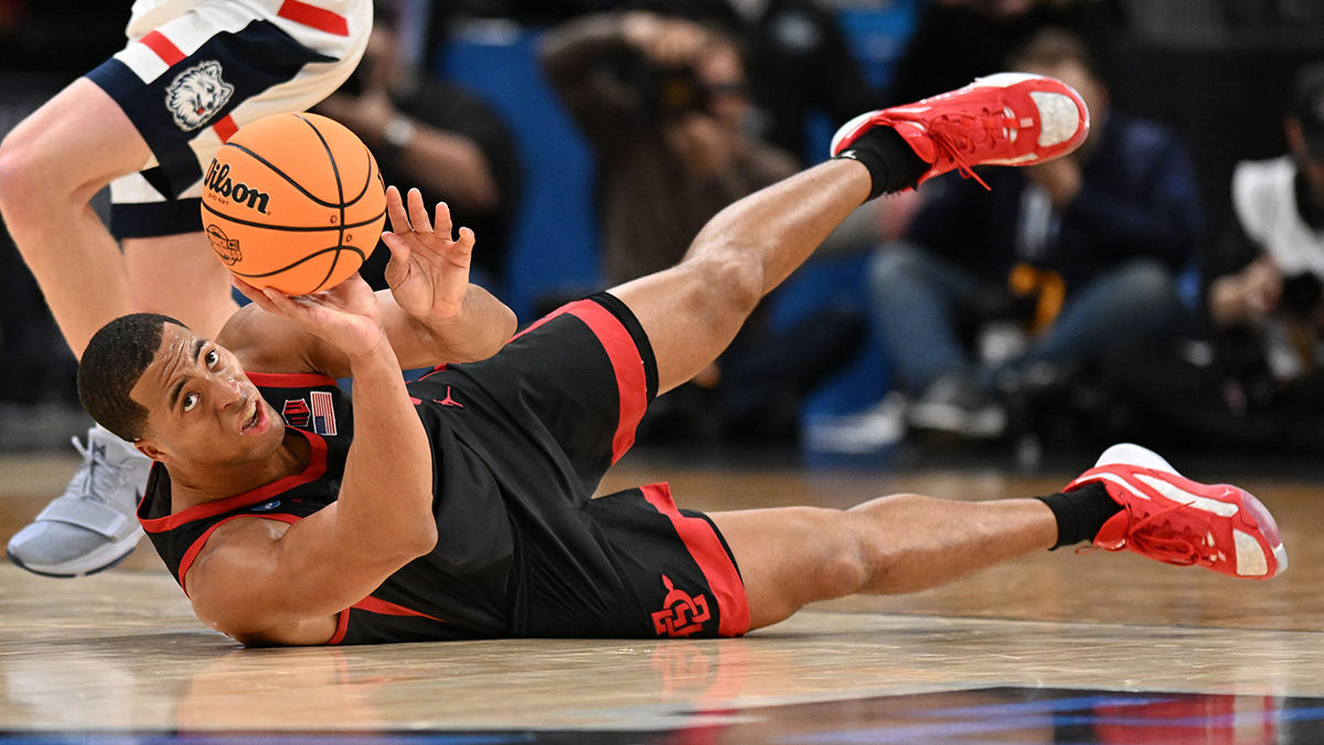 San Diego State Aztecs forward Jaedon LeDee (13) dives for a loose ball against the Connecticut Huskies in the semifinals of the East Regional of the 2024 NCAA Tournament at TD Garden. The Minnesota Timberwolves signed LeDee to an Exhibit 10 deal prior to training camp.