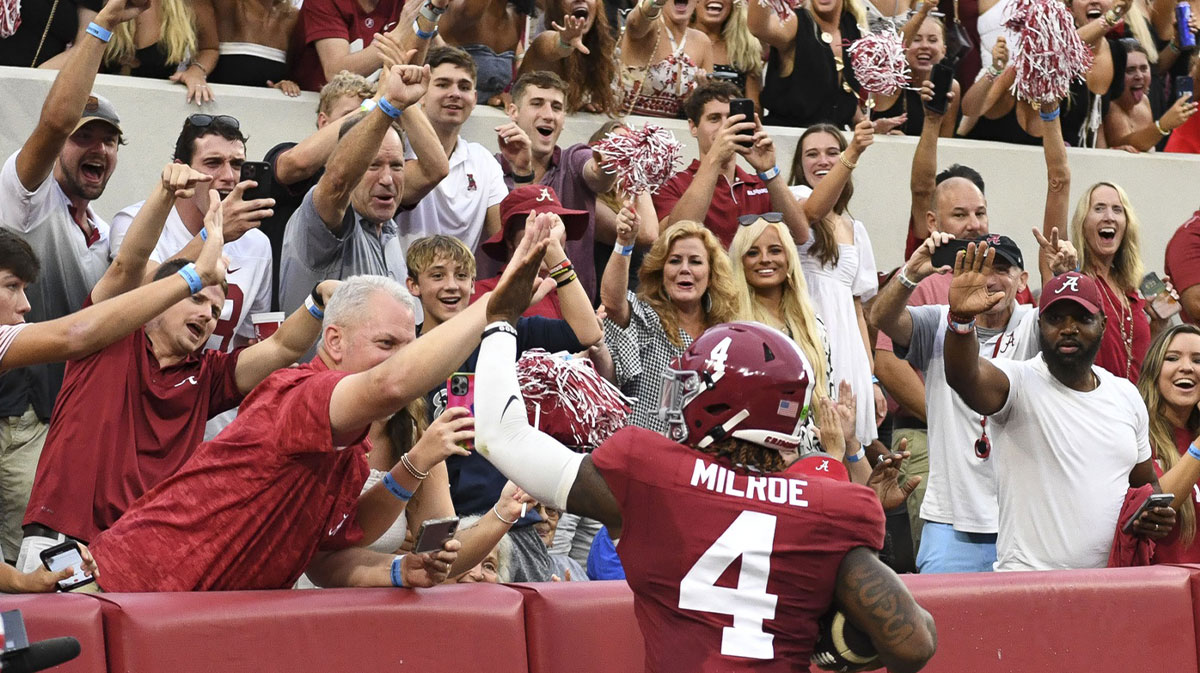 Alabama Crimson Tide quarterback Jalen Milroe (4) celebrates with fans after scoring against the Western Kentucky Hilltoppers during the first half at Bryant-Denny Stadium.