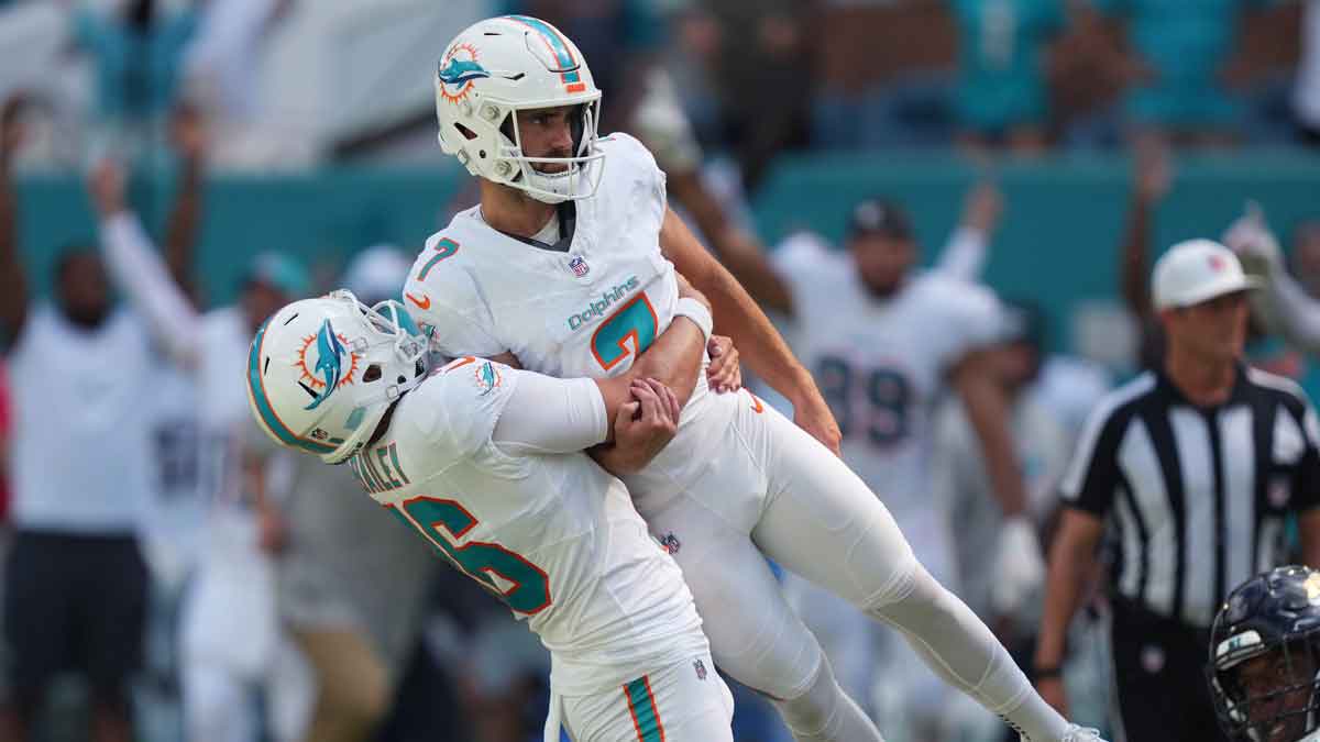 Miami Dolphins punter Jake Bailey (16) lifts Miami Dolphins place kicker Jason Sanders (7) after his game winning field goal against the Jacksonville Jaguars at Hard Rock Stadium.