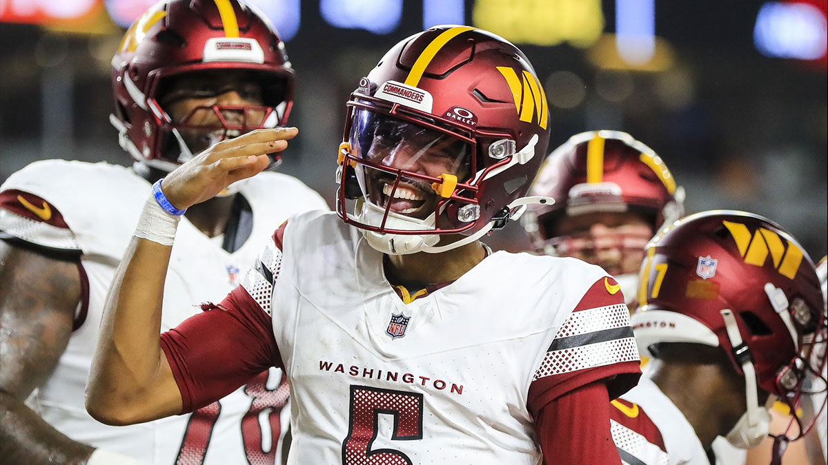 Washington Commanders quarterback Jayden Daniels (5) reacts after scoring a touchdown against the Cincinnati Bengals in the first half at Paycor Stadium.