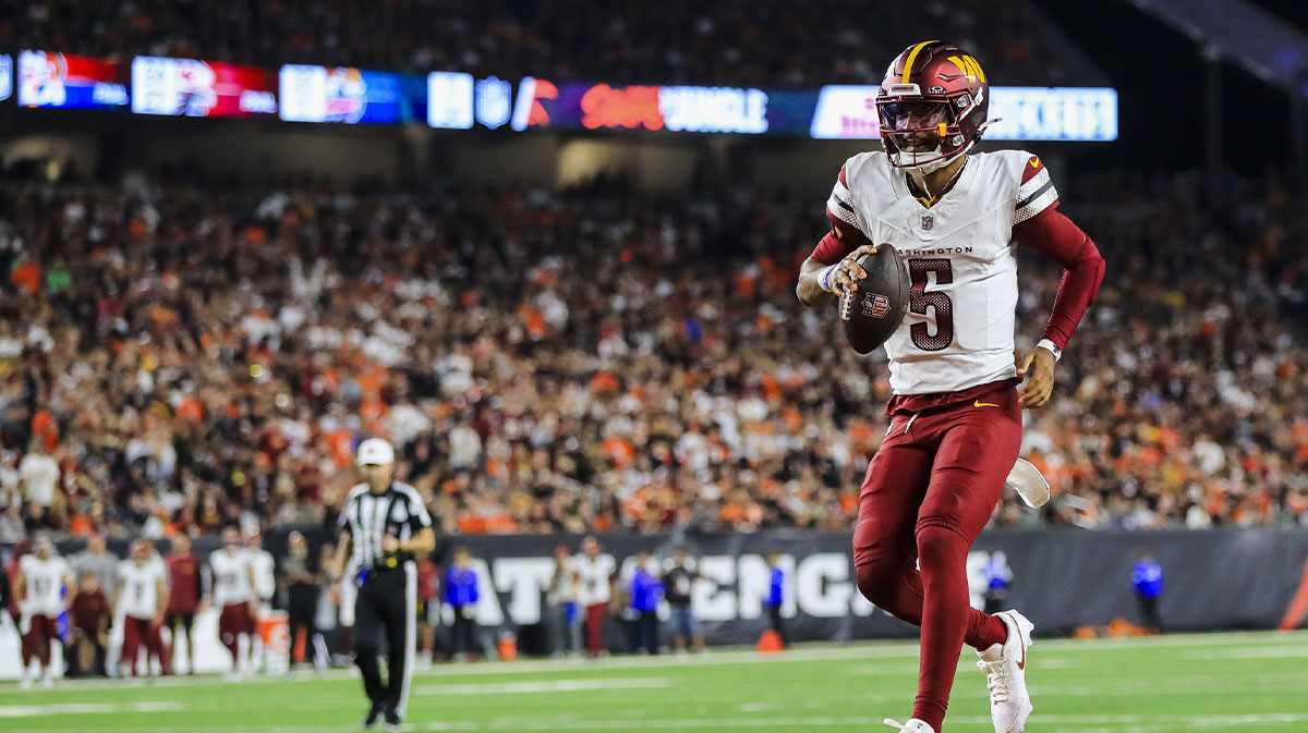Sep 23, 2024; Cincinnati, Ohio, USA; Washington Commanders quarterback Jayden Daniels (5) runs the ball in for a touchdown against the Cincinnati Bengals at Paycor Stadium.