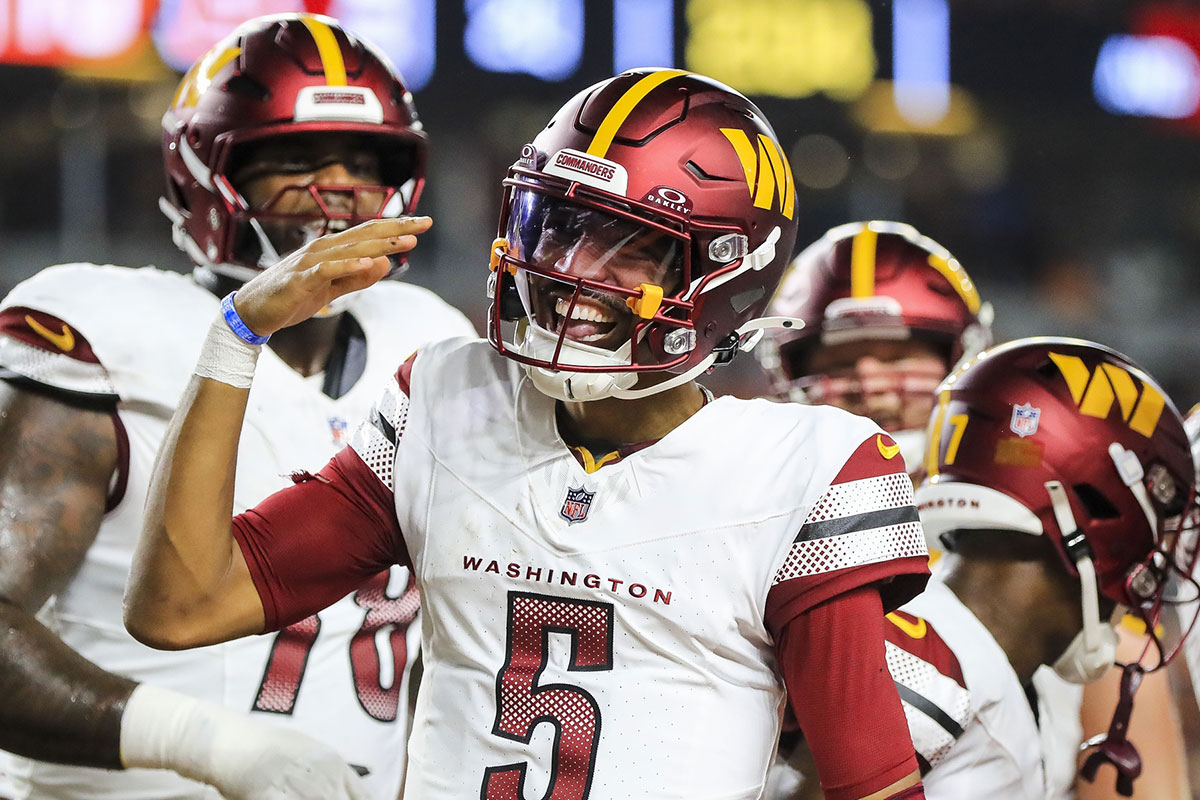 Washington Commanders quarterback Jayden Daniels (5) reacts after scoring a touchdown against the Cincinnati Bengals in the first half at Paycor Stadium.