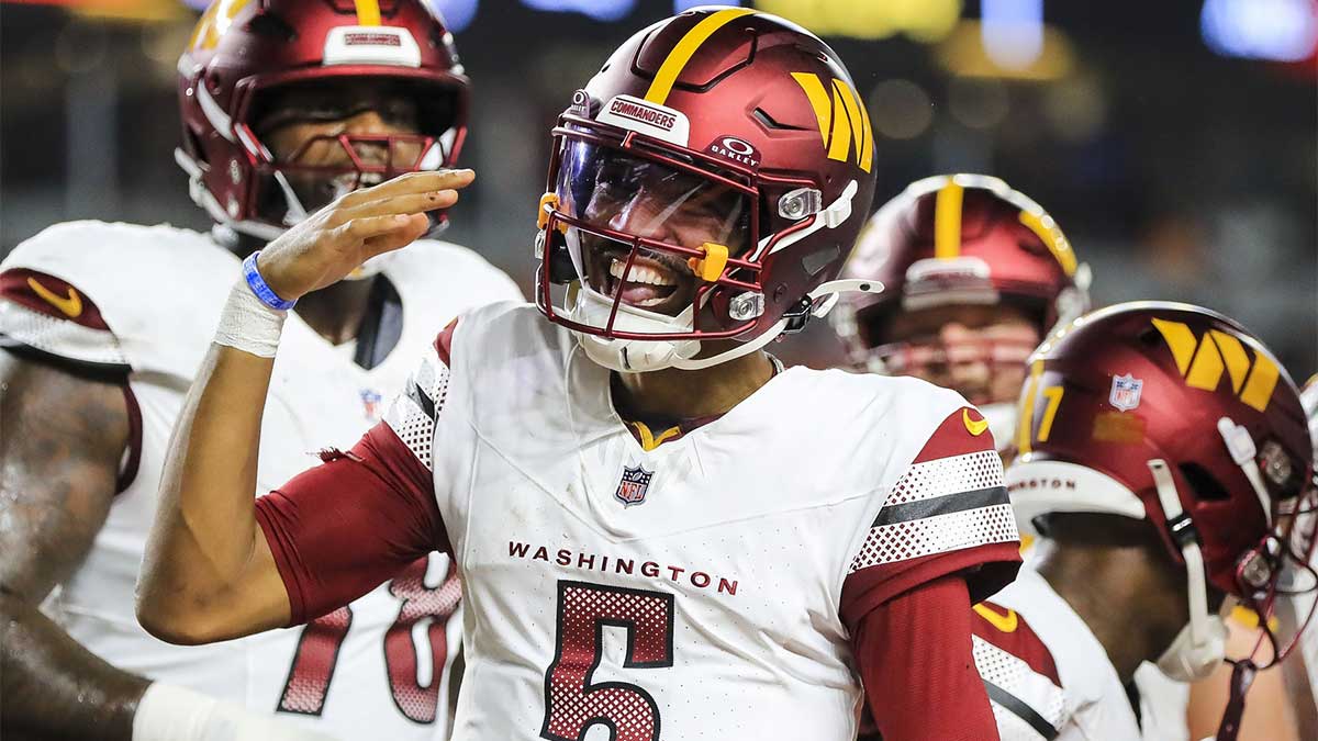 Washington Commanders quarterback Jayden Daniels (5) reacts after scoring a touchdown against the Cincinnati Bengals in the first half at Paycor Stadium.