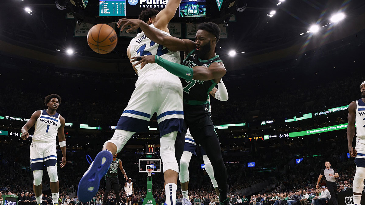 Boston Celtics guard Jaylen Brown (7) passes around Minnesota Timberwolves center Karl-Anthony Towns (32) during the second quarter at TD Garden.