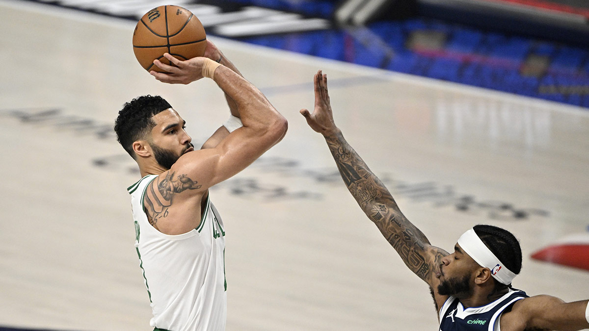 Boston Celtics forward Jayson Tatum (0) shoots against Dallas Mavericks guard Jaden Hardy (1) during the first quarter of Game 3 of the 2024 NBA Finals at American Airlines Center.