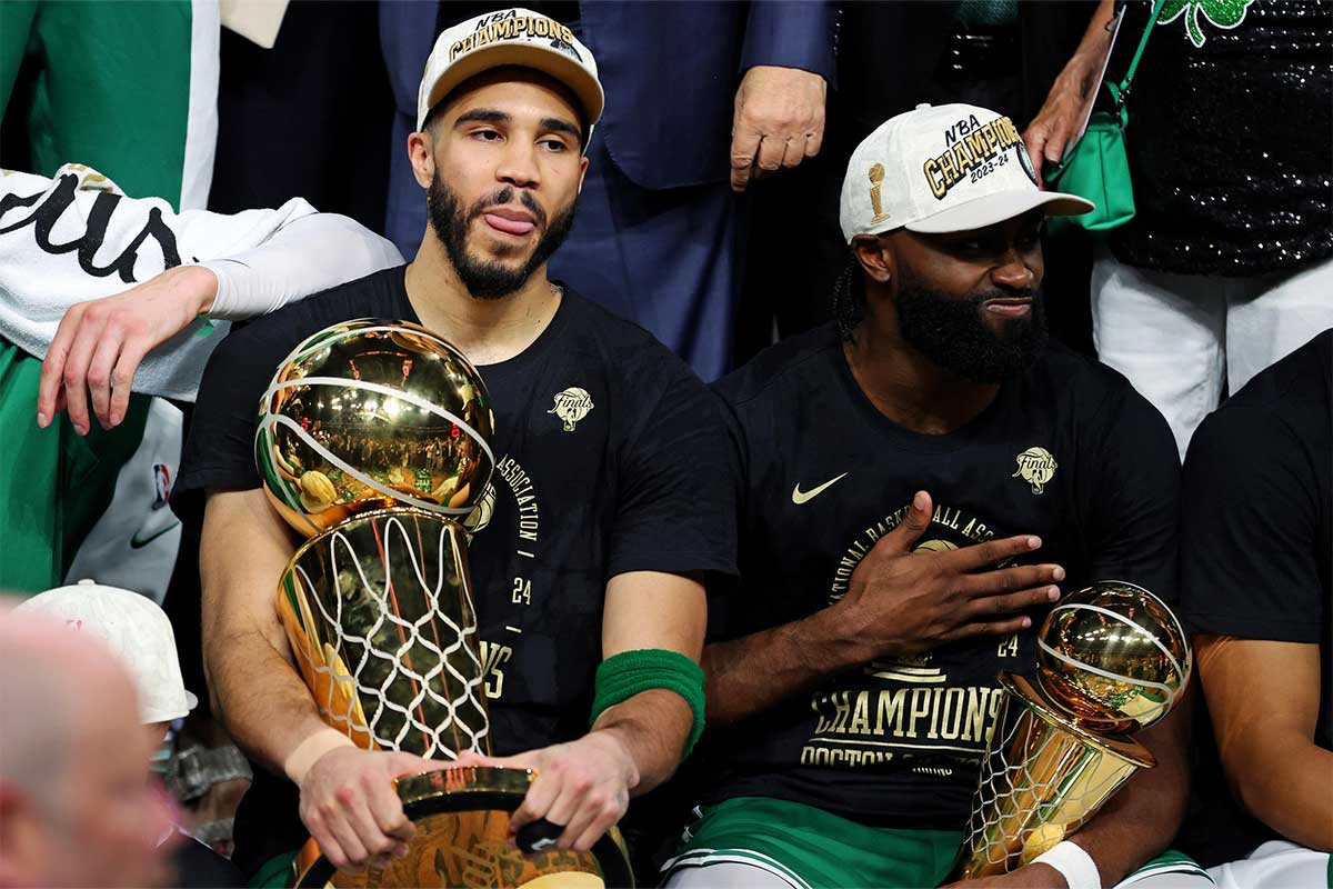 Boston Celtics forward Jayson Tatum (0) and guard Jaylen Brown (7) celebrates with the Larry O’Brian Trophy after beating the Dallas Mavericks in game five of the 2024 NBA Finals to win the NBA Championship at TD Garden.