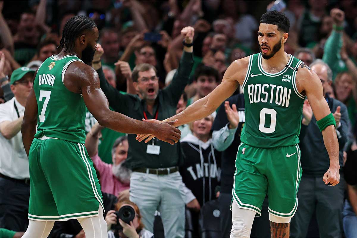 Boston Celtics forward Jayson Tatum (0) celebrates with guard Jaylen Brown (7) after a play against the Dallas Mavericks in game five of the 2024 NBA Finals at TD Garden.