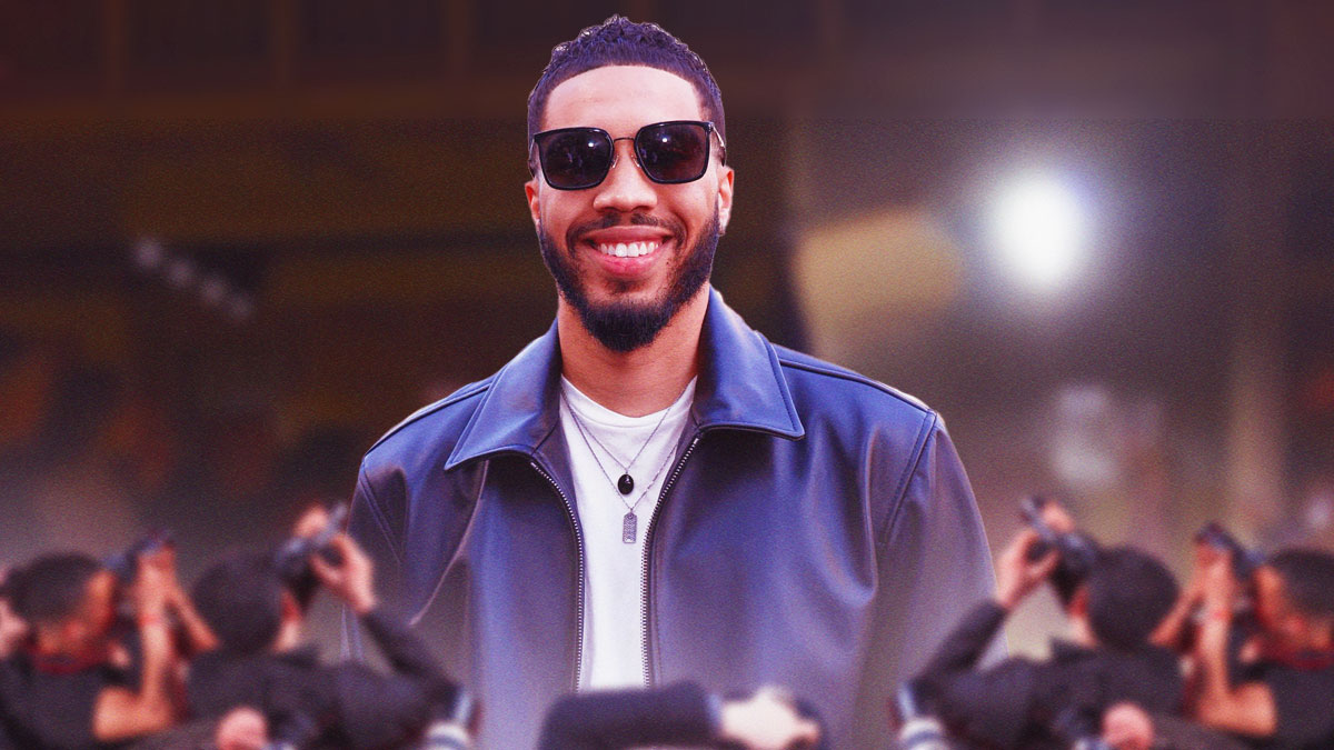 Jayson Tatum as a model at Coach Fashion Week with cameras flashing around him