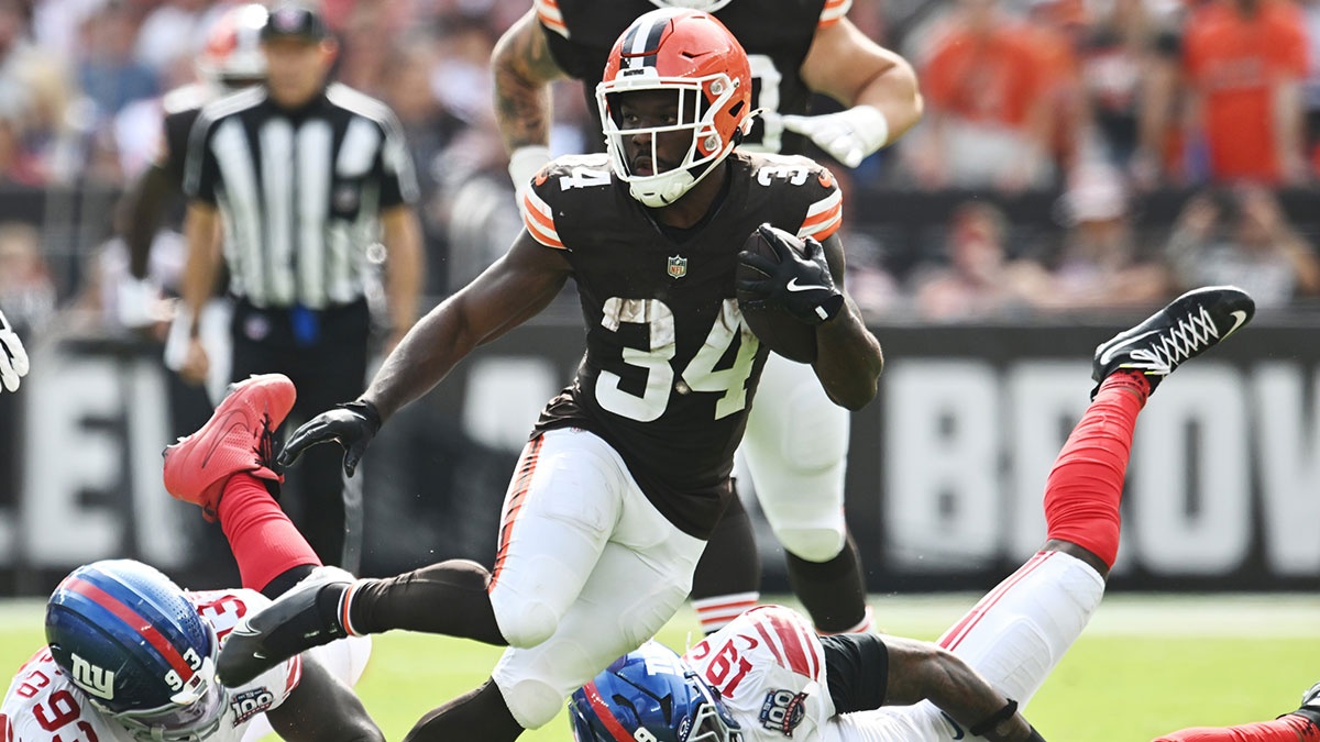 Cleveland Browns running back Jerome Ford (34) runs between New York Giants defensive tackle Rakeem Nunez-Roches (93) and linebacker Isaiah Simmons (19) during the second half at Huntington Bank Field.