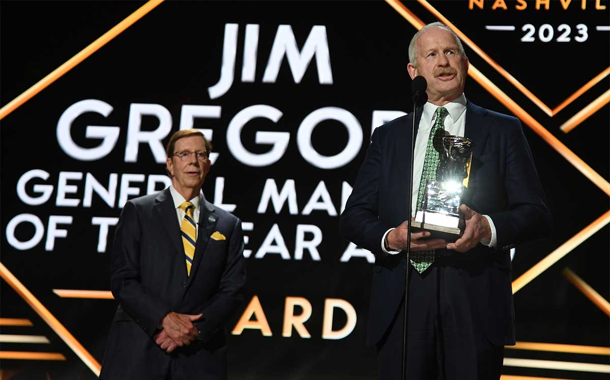 Dallas Stars general manager Jim Nill is awarded the Jim Gregory General Manager of the Year award by Nashville Predators general manager David Poile during the first round of the 2023 NHL Draft at Bridgestone Arena.