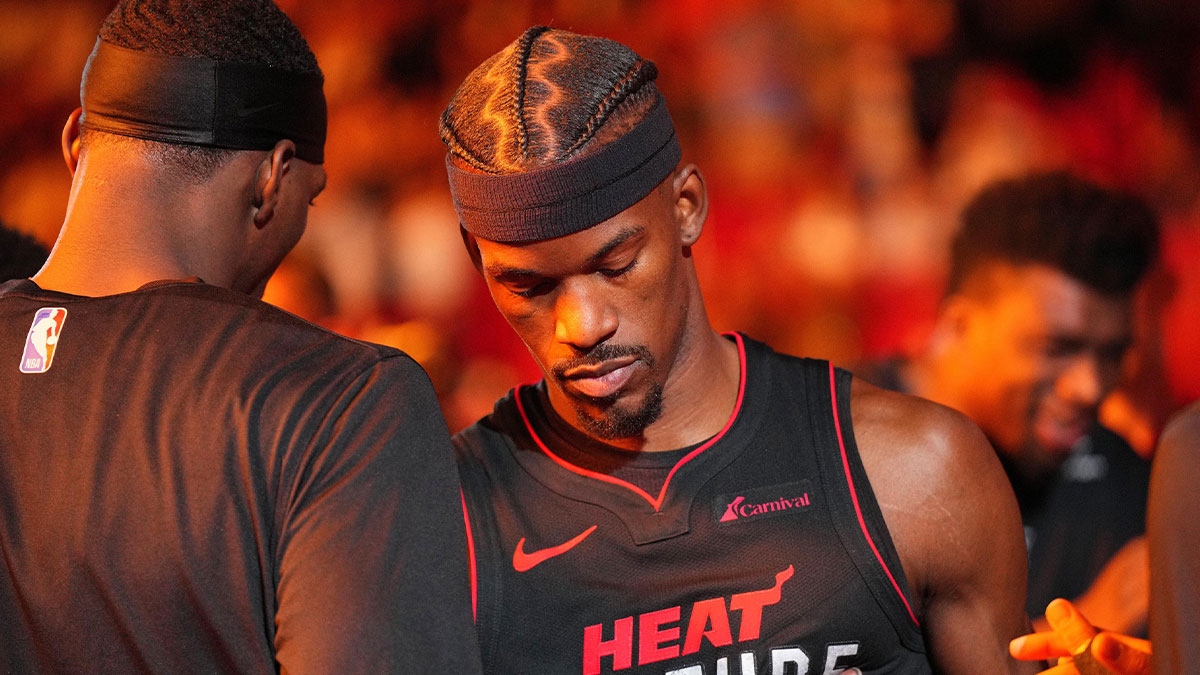 Miami Heat forward Jimmy Butler, right, greets center Bam Adebayo during ceremonies before a game against the Philadelphia 76ers at Kaseya Center.