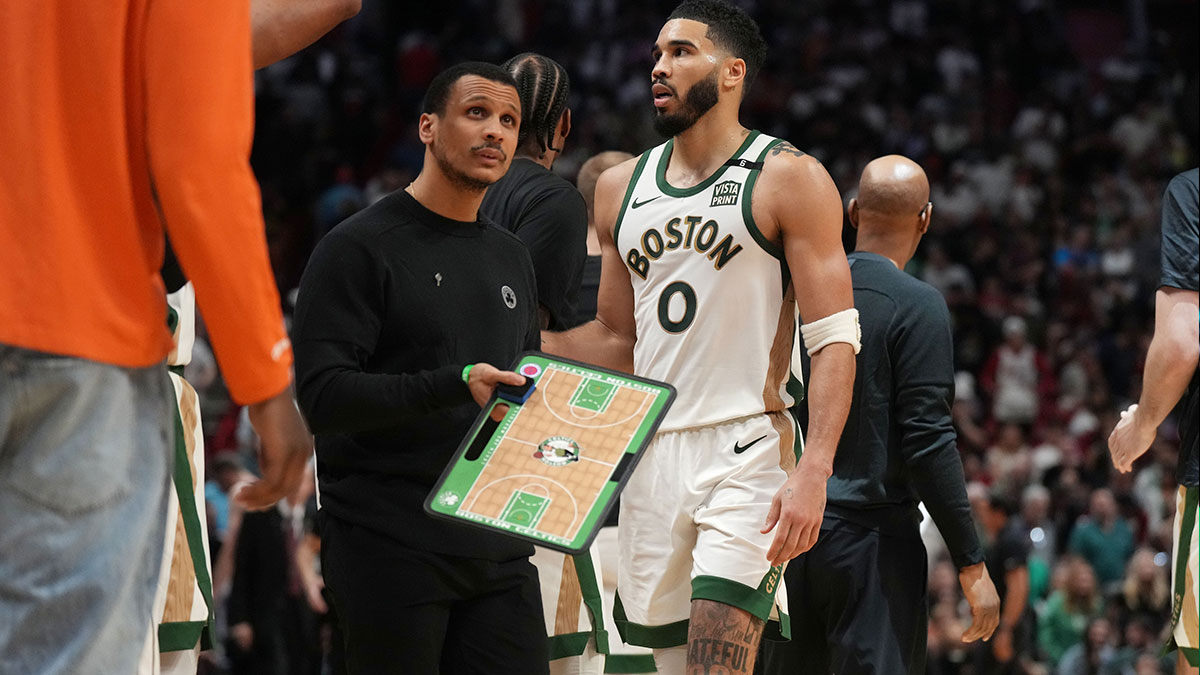 Boston Celtics head coach Joe Mazzulla and forward Jayson Tatum (0) during a timeout the second half at Kaseya Center against the Miami Heat. 