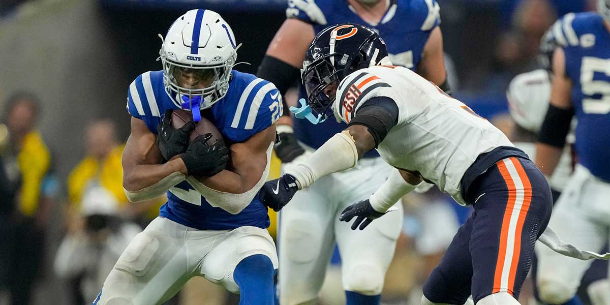Indianapolis Colts running back Jonathan Taylor (28) looks to move past Chicago Bears safety Jaquan Brisker (9) on Sunday, Sept. 22, 2024, during a game against the Chicago Bears at Lucas Oil Stadium in Indianapolis.