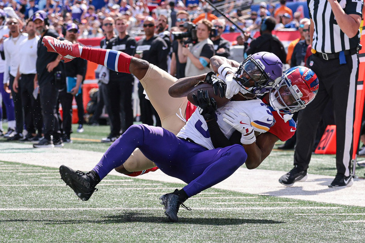 Minnesota Vikings wide receiver Jordan Addison (3) is tackled by New York Giants cornerback Dru Phillips (22) during the first half at MetLife Stadium.