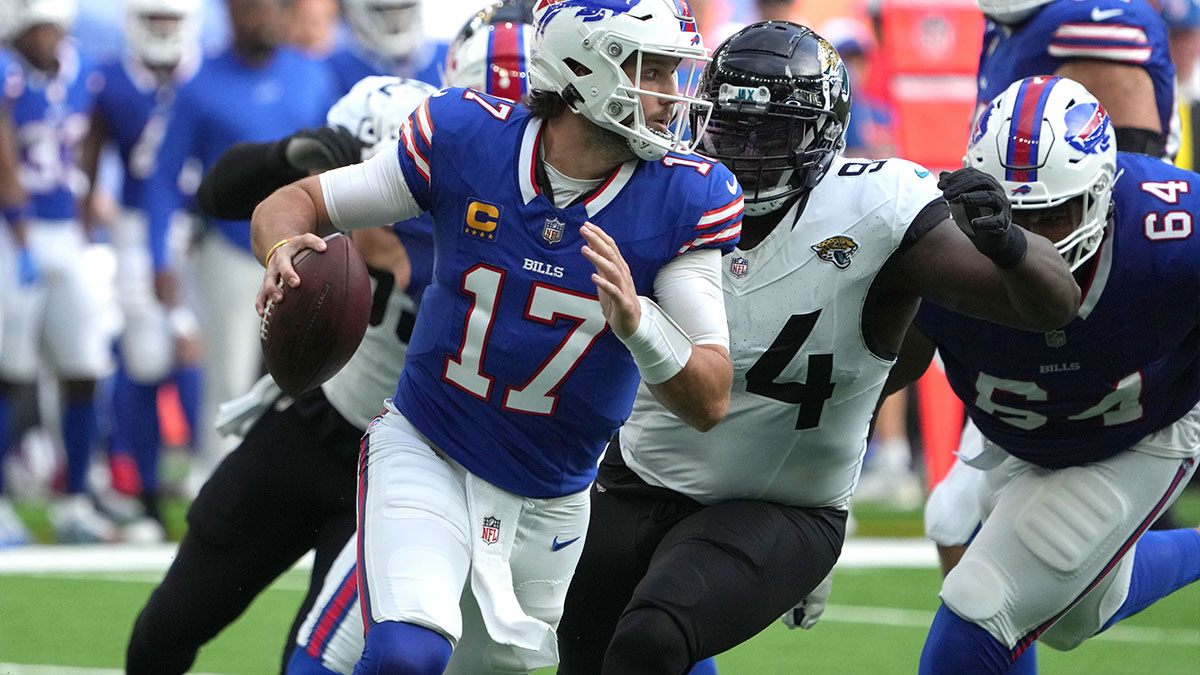 Buffalo Bills quarterback Josh Allen (17)] throws the ball under pressure from Jacksonville Jaguars defensive tackle Folorunso Fatukasi (94) during the first half of an NFL International Series game at Tottenham Hotspur Stadium. 