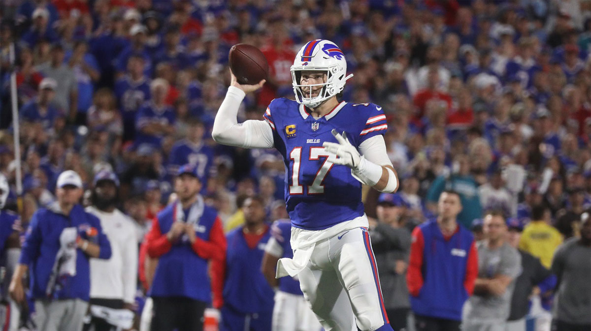 Bills quarterback Josh Allen pretends he is going to throw a pass before running for several yards during second half action