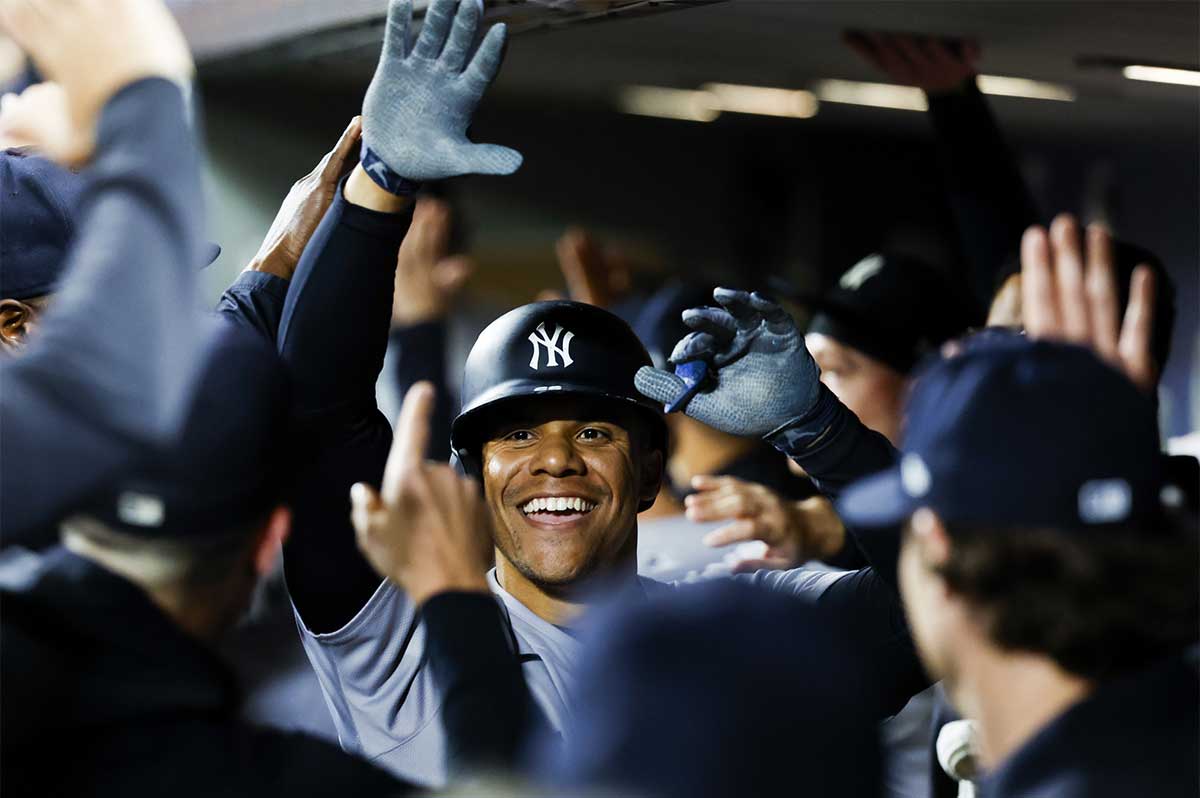 New York Yankees right fielder Juan Soto (22) celebrates with teammates in the dugout after hitting a two-run home run against the Seattle Mariners during the fourth inning at T-Mobile Park.