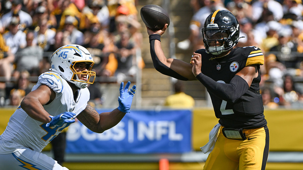 Pittsburgh Steelers quarterback Justin Fields (2) throws a pass while under pressure from Los Angeles Chargers linebacker Tuli Tuipulotu (45) during the first quarter at Acrisure Stadium.