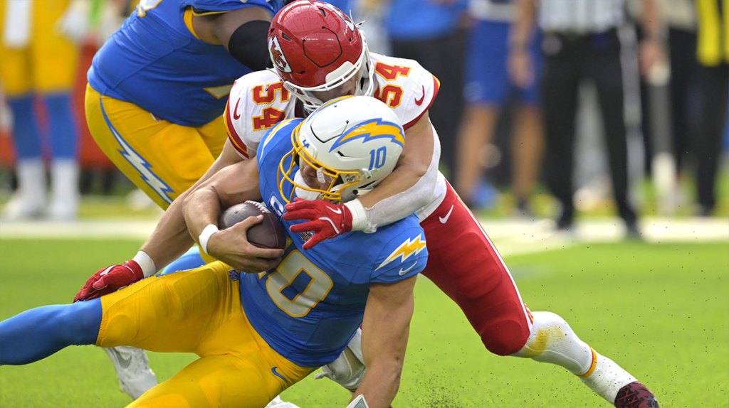 Los Angeles Chargers quarterback Justin Herbert (10) is sacked by Kansas City Chiefs linebacker Leo Chenal (54) in the first half at SoFi Stadium.