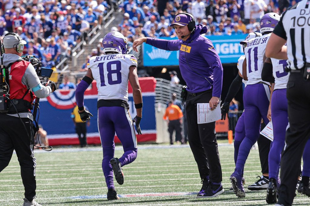 Minnesota Vikings wide receiver Justin Jefferson (18) celebrates head coach Kevin O'Connell after his touchdown reception during the first half against the New York Giants at MetLife Stadium. 