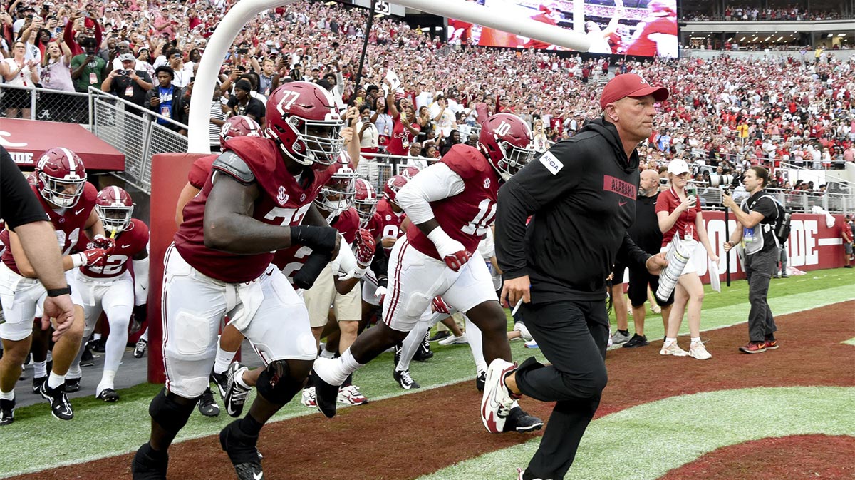 Alabama Crimson Tide head coach Kalen DeBoer leads his players onto the field at Bryant-Denny Stadium for his first game as head coach. The Crimson Tide played Western Kentucky Hilltoppers.