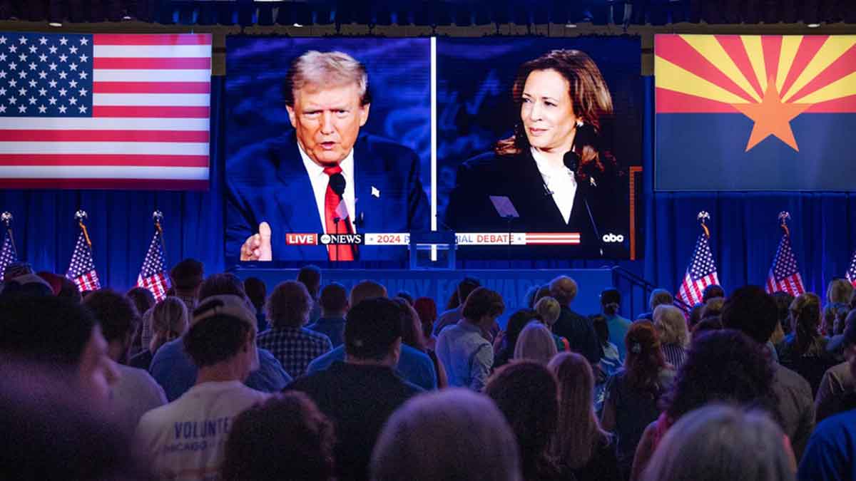 People react at the Mesa Convention Center while watching former President Donald J. Trump and Vice President Kamala Harris debate on Sept. 10, 2024.