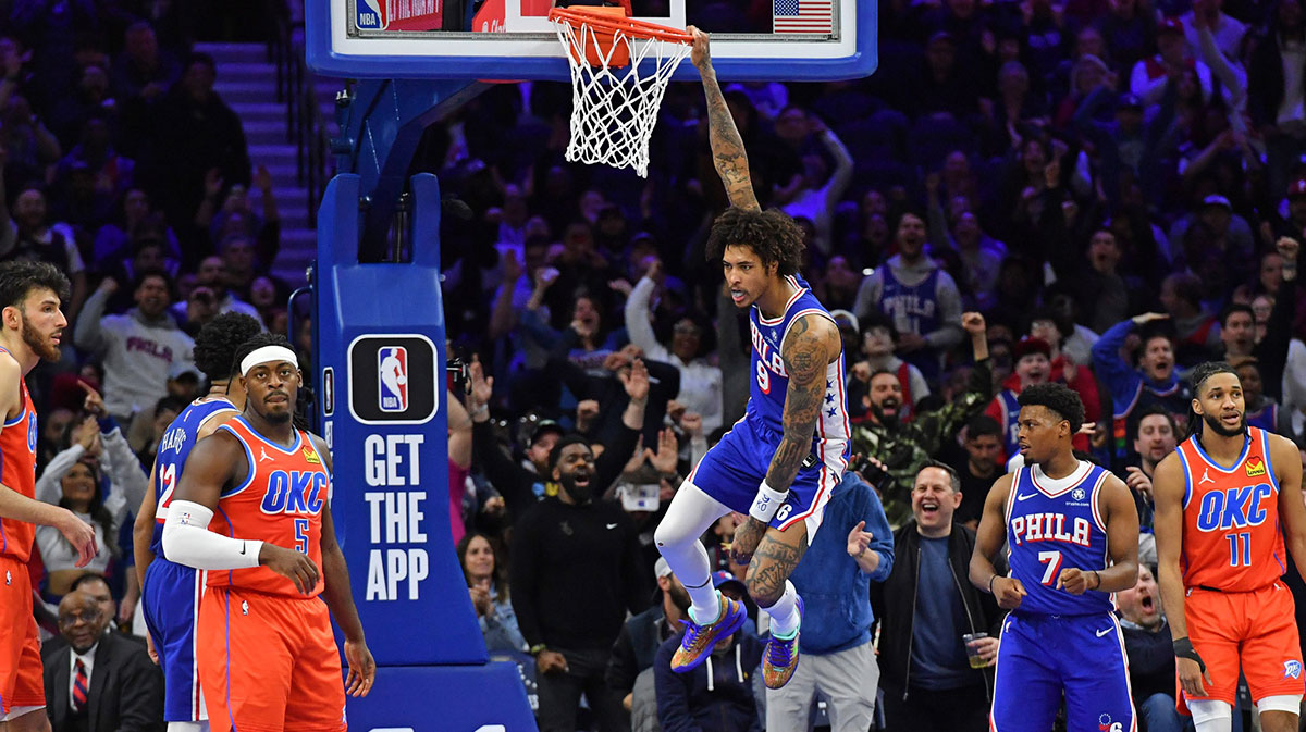 Apr 2, 2024; Philadelphia, Pennsylvania, USA; Philadelphia 76ers guard Kelly Oubre Jr. (9) hangs on the rim after a slam dunk against the Oklahoma City Thunder during the fourth quarter at Wells Fargo Center. Mandatory Credit: Eric Hartline-Imagn Images