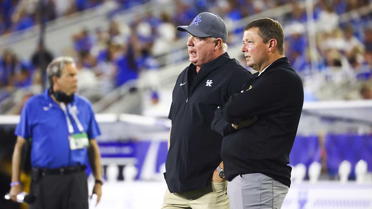 Kentucky Wildcats head coach Mark Stoops (left) and Southern Miss Golden Eagles head coach Will Hall speak during the lightning delay at Kroger Field.