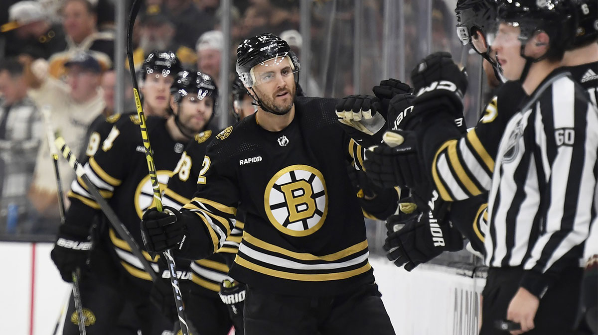 Boston Bruins defenseman Kevin Shattenkirk (12) celebrates with teammates after scoring a goal against the Arizona Coyotes during the second period at TD Garden.
