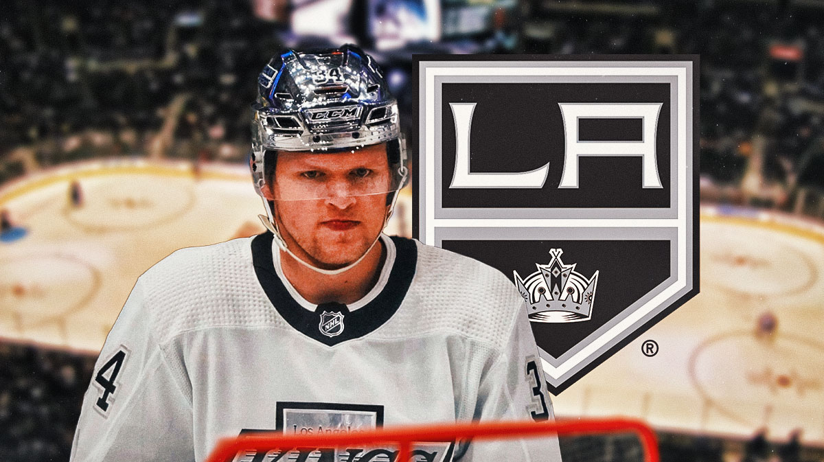Kings winger Arthur Kaliyev on a hockey rink next to the Kings logo