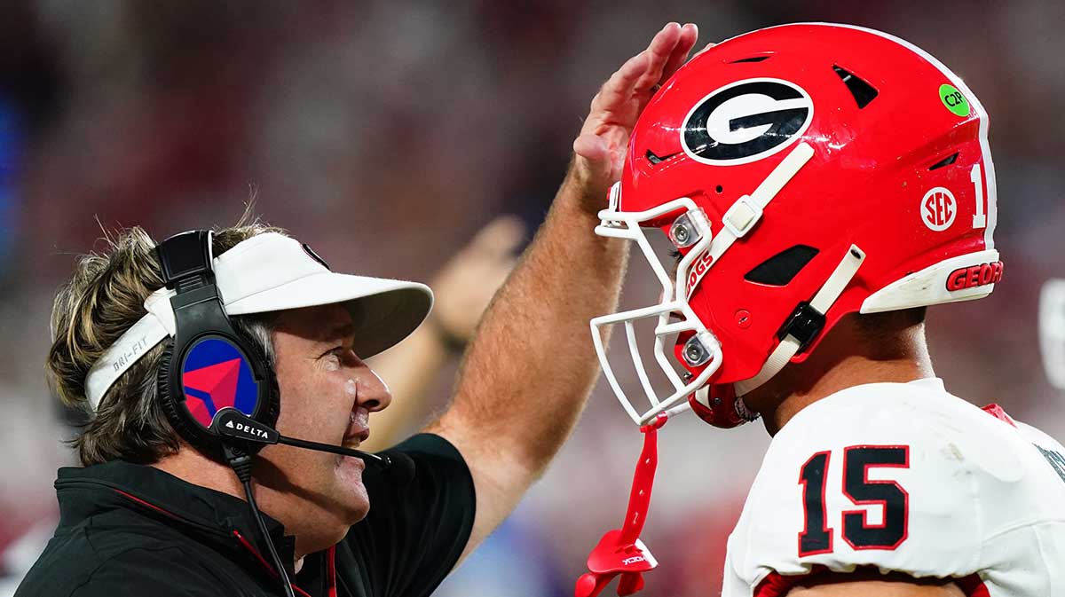 Georgia Bulldogs head coach Kirby Smart talks with quarterback Carson Beck (15) during the first half against the Alabama Crimson Tide at Bryant-Denny Stadium.
