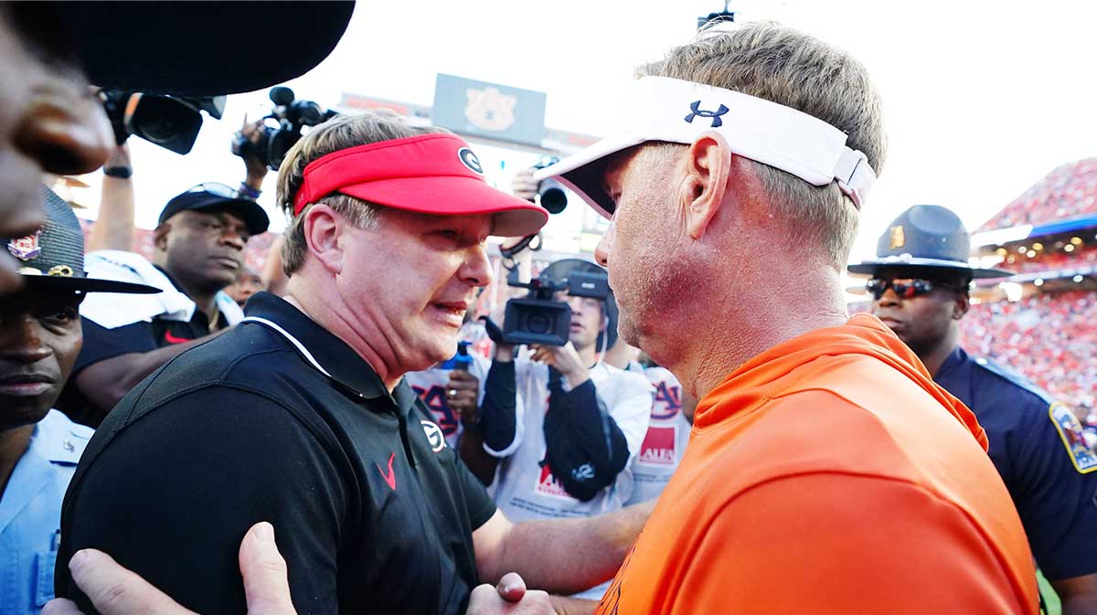 Georgia Bulldogs head coach Kirby Smart meets Auburn Tigers head coach Hugh Freeze midfield following the Bulldogs 27-20 victory at Jordan-Hare Stadium.
