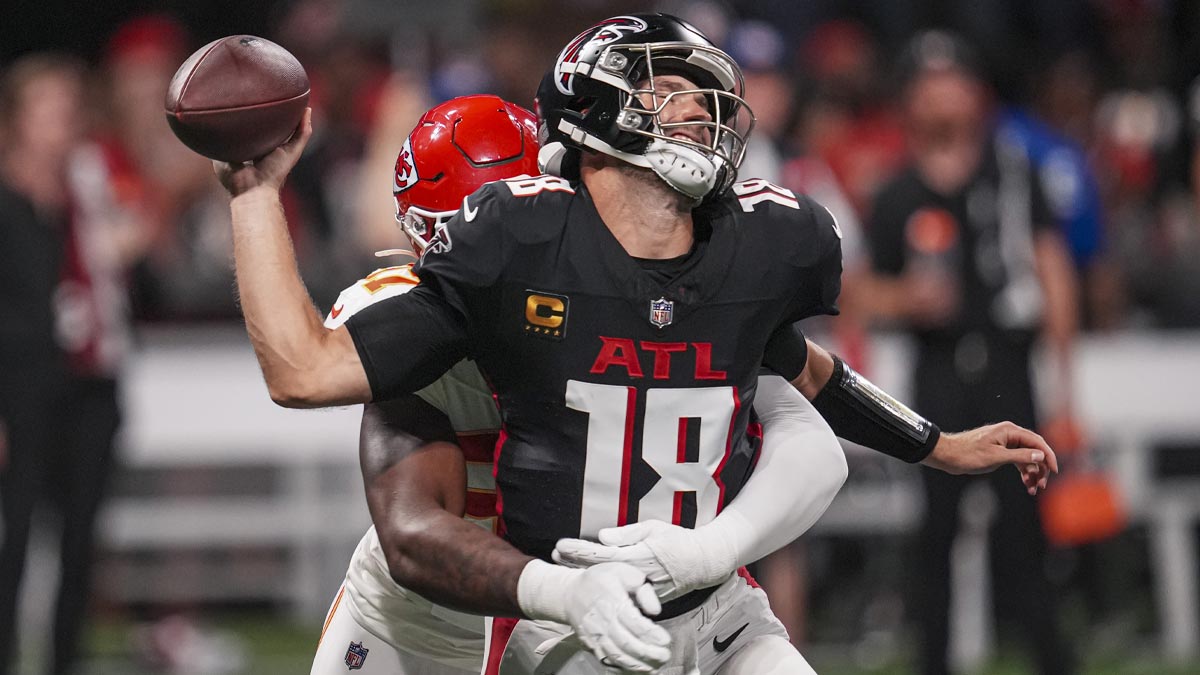 Atlanta Falcons quarterback Kirk Cousins (18) is hit by Kansas City Chiefs defensive end Felix Anudike-Uzomah (97) and fumbles the ball during the first half at Mercedes-Benz Stadium.