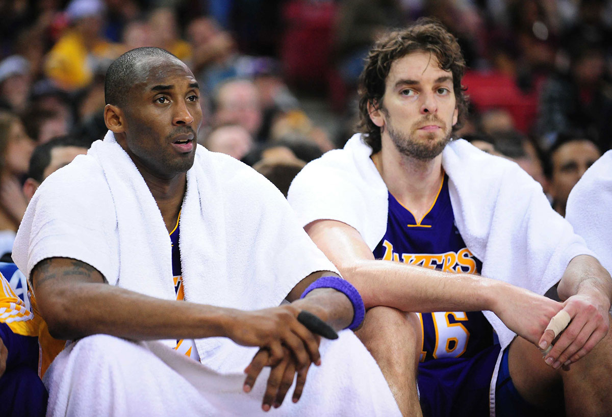 Los Angeles Lakers guard Kobe Bryant (left) and forward Pau Gasol (right) rest on the bench during the second quarter against the Sacramento Kings at Arco Arena. The Lakers defeated the Kings 112-103 in double overtime.