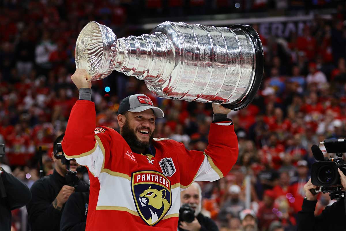 Florida Panthers forward Kyle Okposo (8) hoists the Stanley Cup after defeating the Edmonton Oilers in game seven of the 2024 Stanley Cup Final at Amerant Bank Arena.