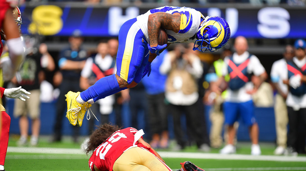 Los Angeles Rams running back Kyren Williams (23) jumps over San Francisco 49ers safety Talanoa Hufanga (29) to score a touchdown during the first half at SoFi Stadium.