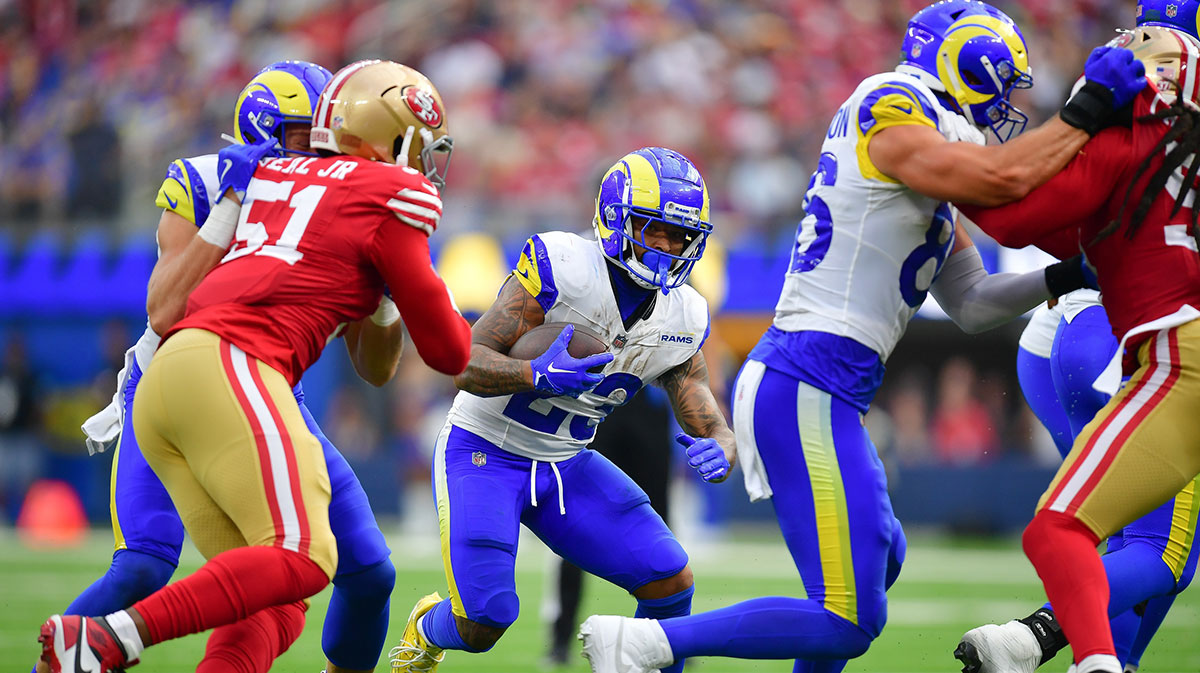 Los Angeles Rams running back Kyren Williams (23) runs the ball against San Francisco 49ers defensive end Robert Beal Jr. (51) during the second half at SoFi Stadium.