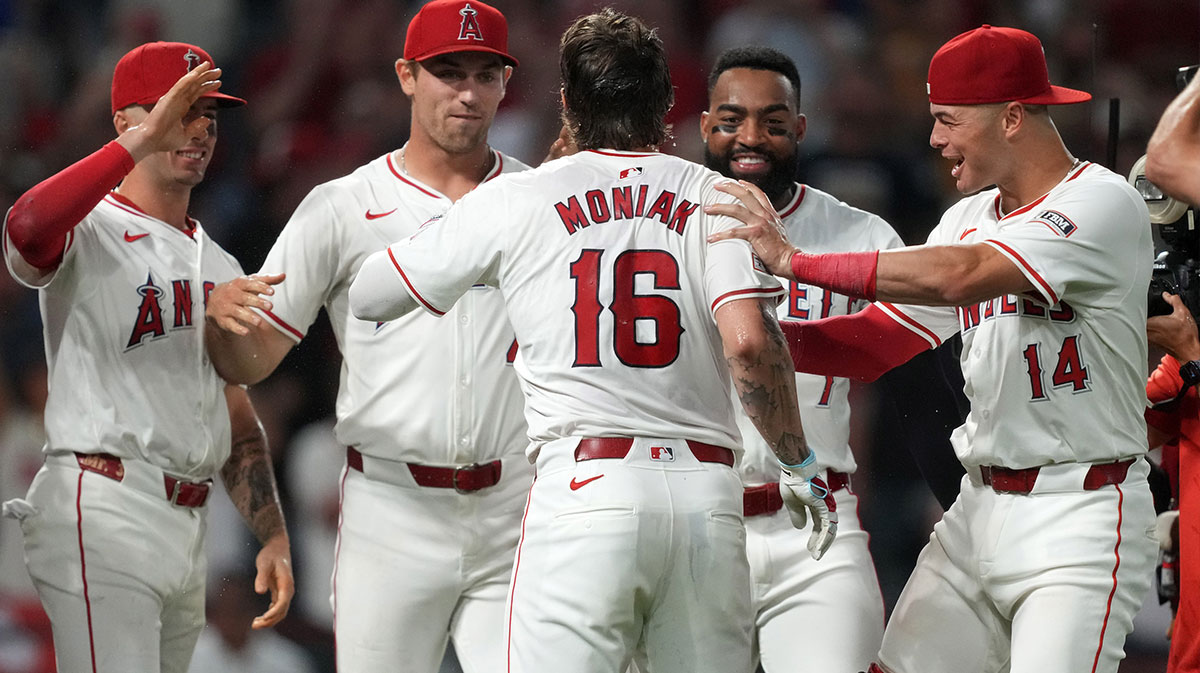 Los Angeles Angels center fielder Mickey Moniak (16) celebrates with teammates after hitting a walk-off home run in the ninth inning against the Seattle Mariners at Angel Stadium.