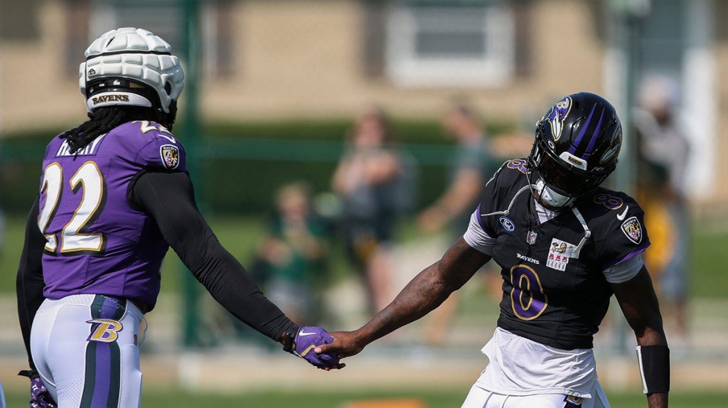 Baltimore Ravens quarterback Lamar Jackson (8) slaps hands with running back Derrick Henry (22) during a joint practice with the Green Bay Packers on Thursday, August 22, 2024, at Ray Nitschke Field in Ashwaubenon, Wis.