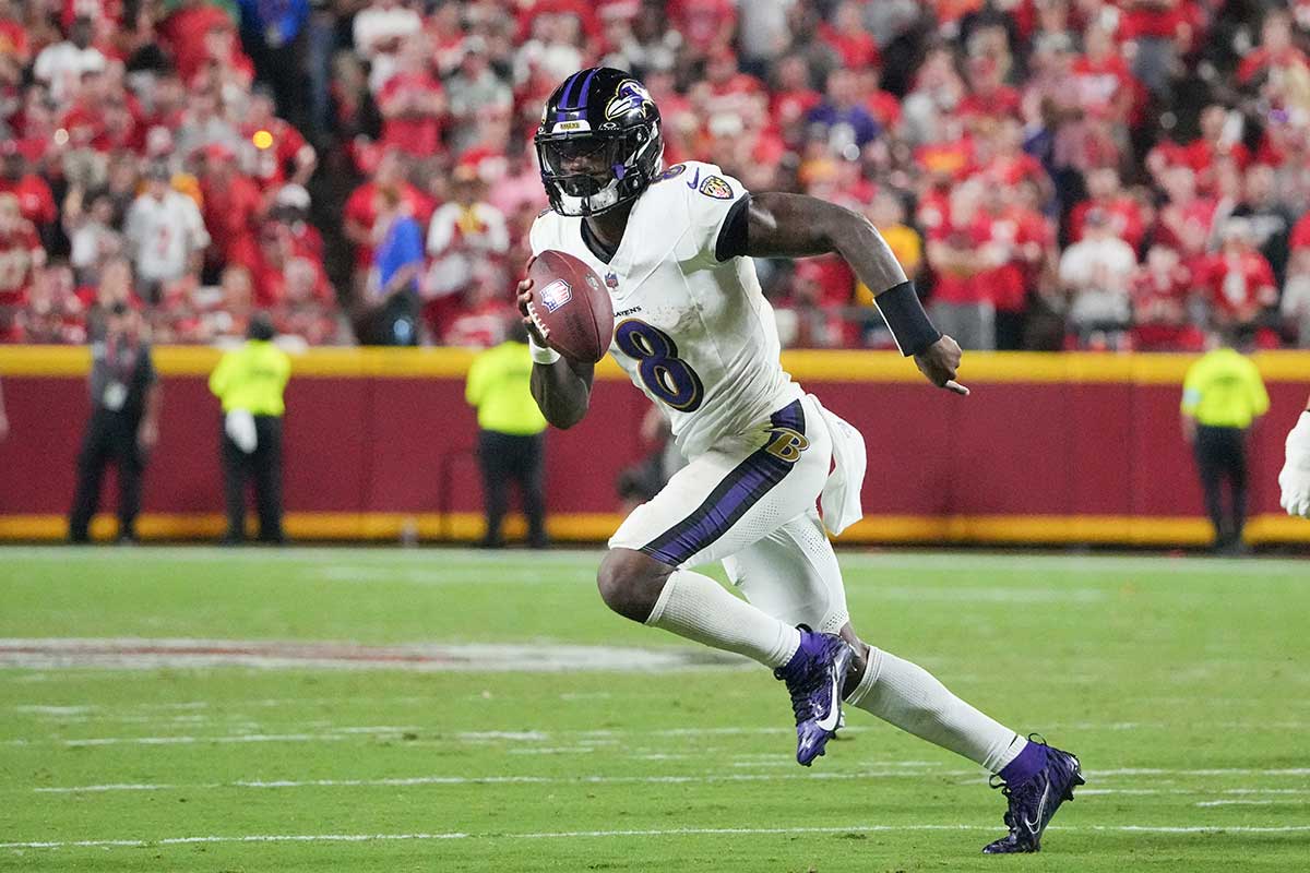 Baltimore Ravens quarterback Lamar Jackson (8) runs the ball against the Kansas City Chiefs during the second half at GEHA Field at Arrowhead Stadium.