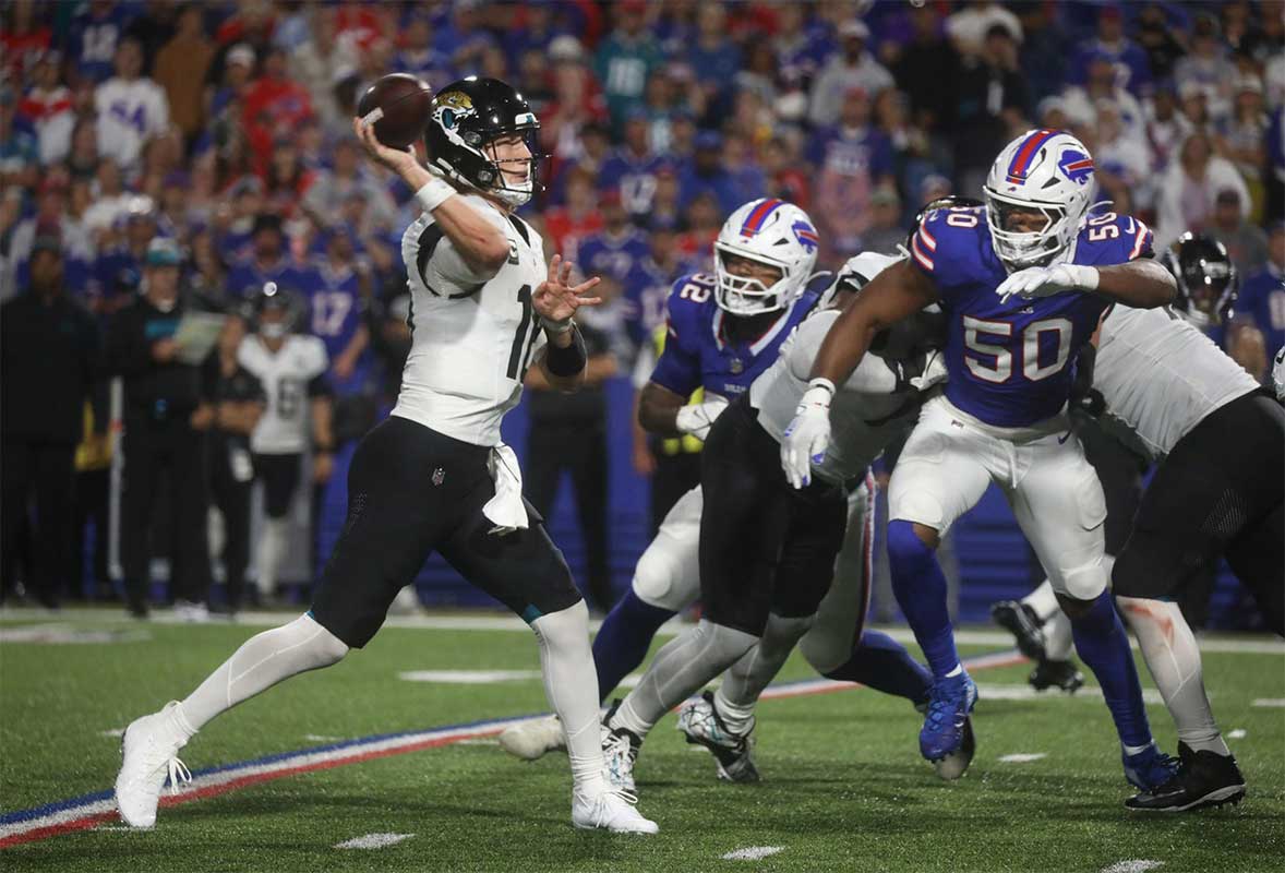 Jaguars quarterback Trevor Lawrence was pressured by the Bills defense breaking through the Jaguars offense line during the second half at Highmark Stadium in Orchard Park on Sept. 23, 2024. Closing in on Lawrence are Bills DaQuan Jones and Greg Rousseau.