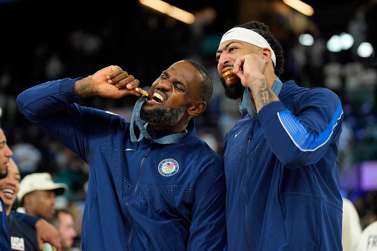 United States guard LeBron James (6) and centre Anthony Davis (14) celebrate after defeating France in the men's basketball gold medal game during the Paris 2024 Olympic Summer Games at Accor Arena.