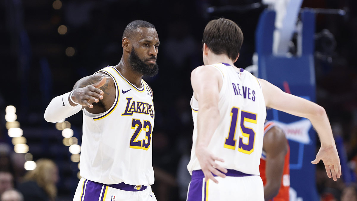 Los Angeles Lakers forward LeBron James (23) and guard Austin Reaves (15) celebrate after a play against the Oklahoma City Thunder during the second half at Paycom Center.