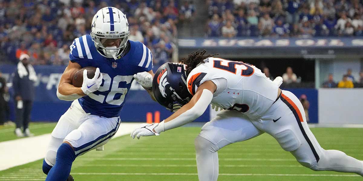 Denver Broncos linebacker Levelle Bailey (56) tackles Indianapolis Colts running back Evan Hull (26) during the first half of a preseason game Sunday, Aug. 11, 2024, at Lucas Oil Stadium in Indianapolis.