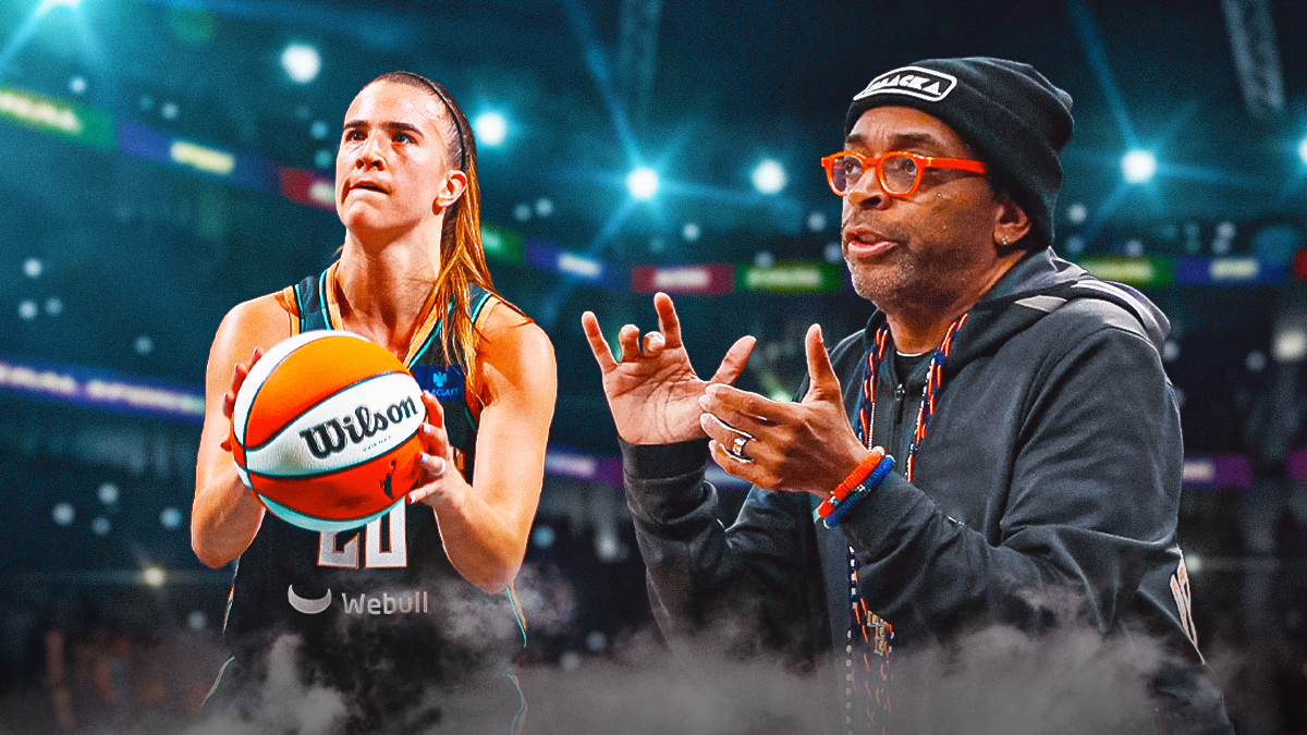 Sabrina Ionescu with the ball and Spike Lee cheering in background. Full Barclays Center behind them.