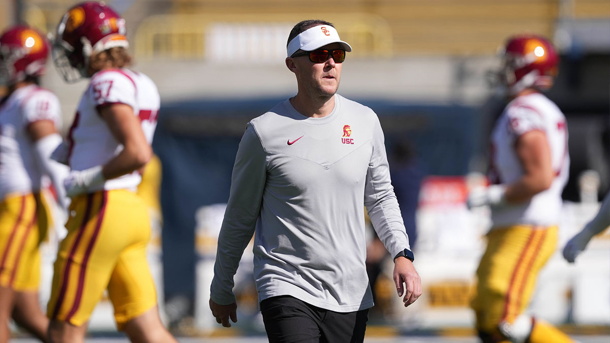 USC Trojans head coach Lincoln Riley (center) walks on the field before the game against the California Golden Bears at California Memorial Stadium.